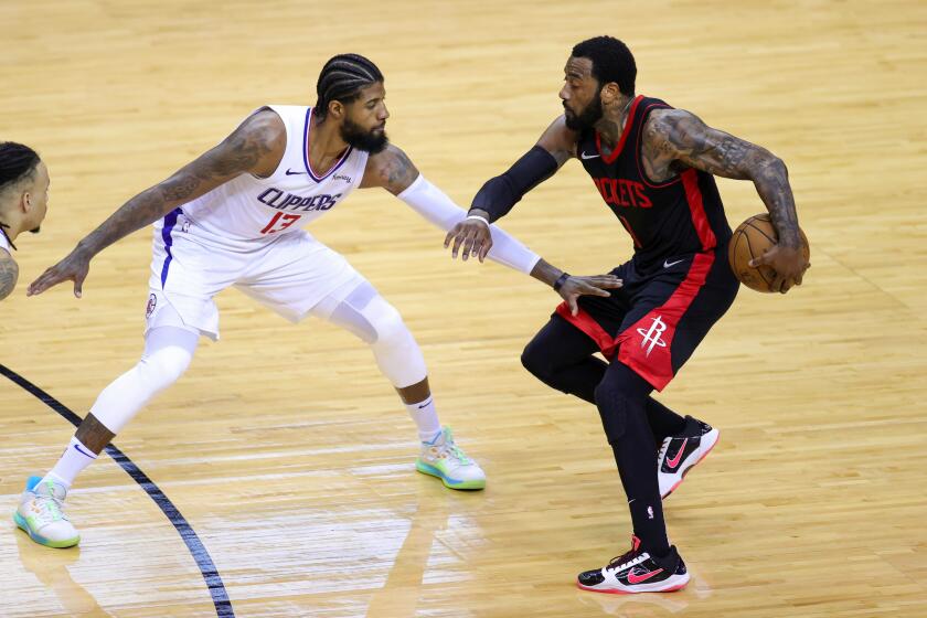 Houston Rockets' John Wall, right, works against Los Angeles Clippers' Paul George