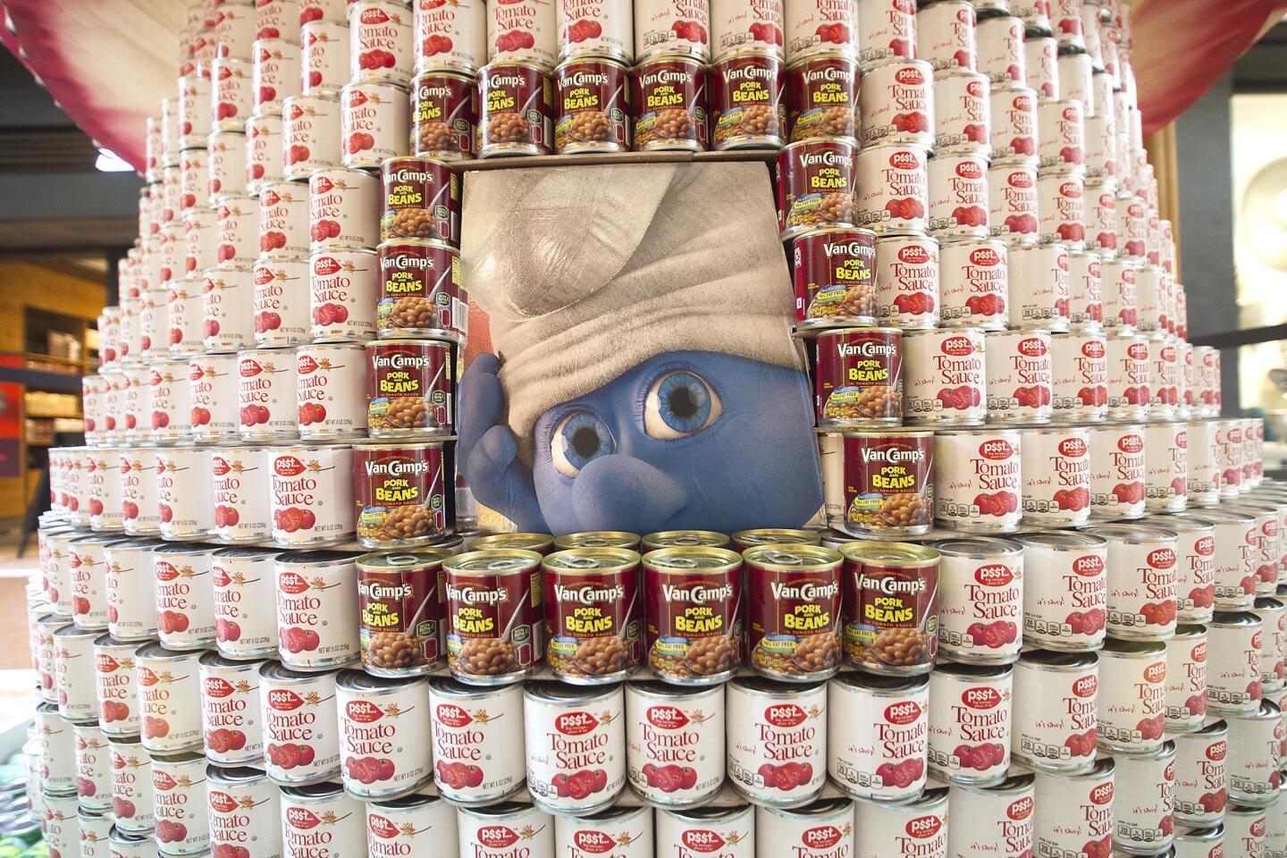McCarthy's "World Hunger - Nothing to Smurf About" themed entry shows a Smurf looking through a window among thousands of cans during the 10th annual Canstruction design and build event at South Coast Plaza in Costa Mesa.