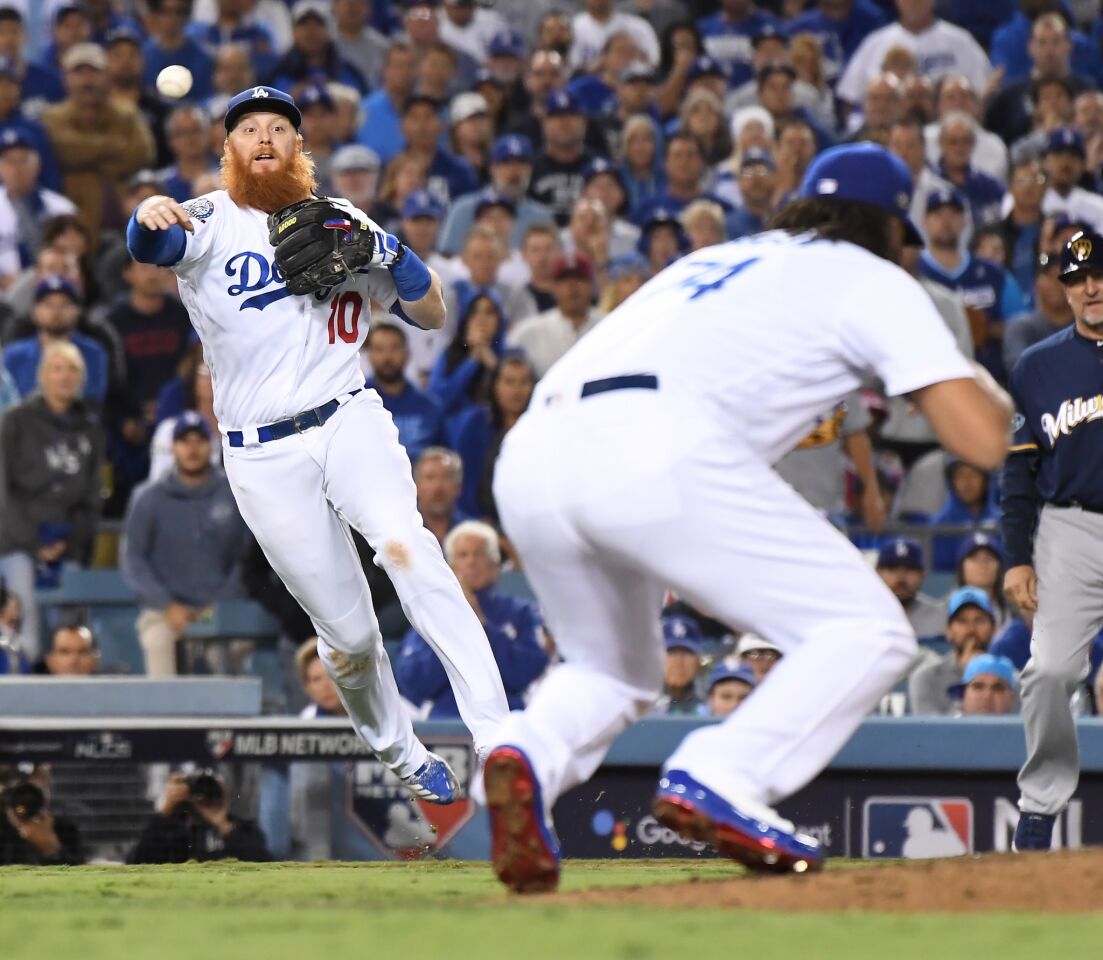 Dodgers Justin Turner throws out Brewers Orlando Arcia in the 9th inning.
