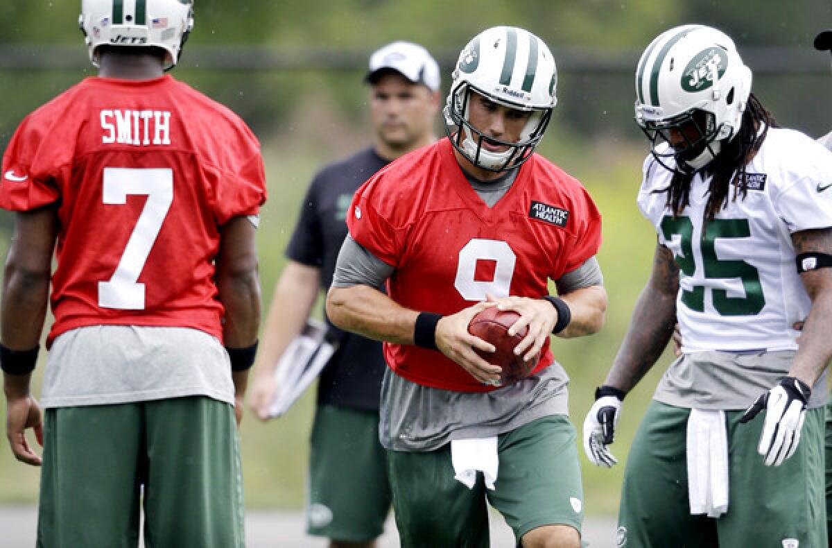 Quarterback Brady Quinn (9) joined rookie Geno Smith and recently acquired running back Alex Green (25) at the Jets' practice on Monday.