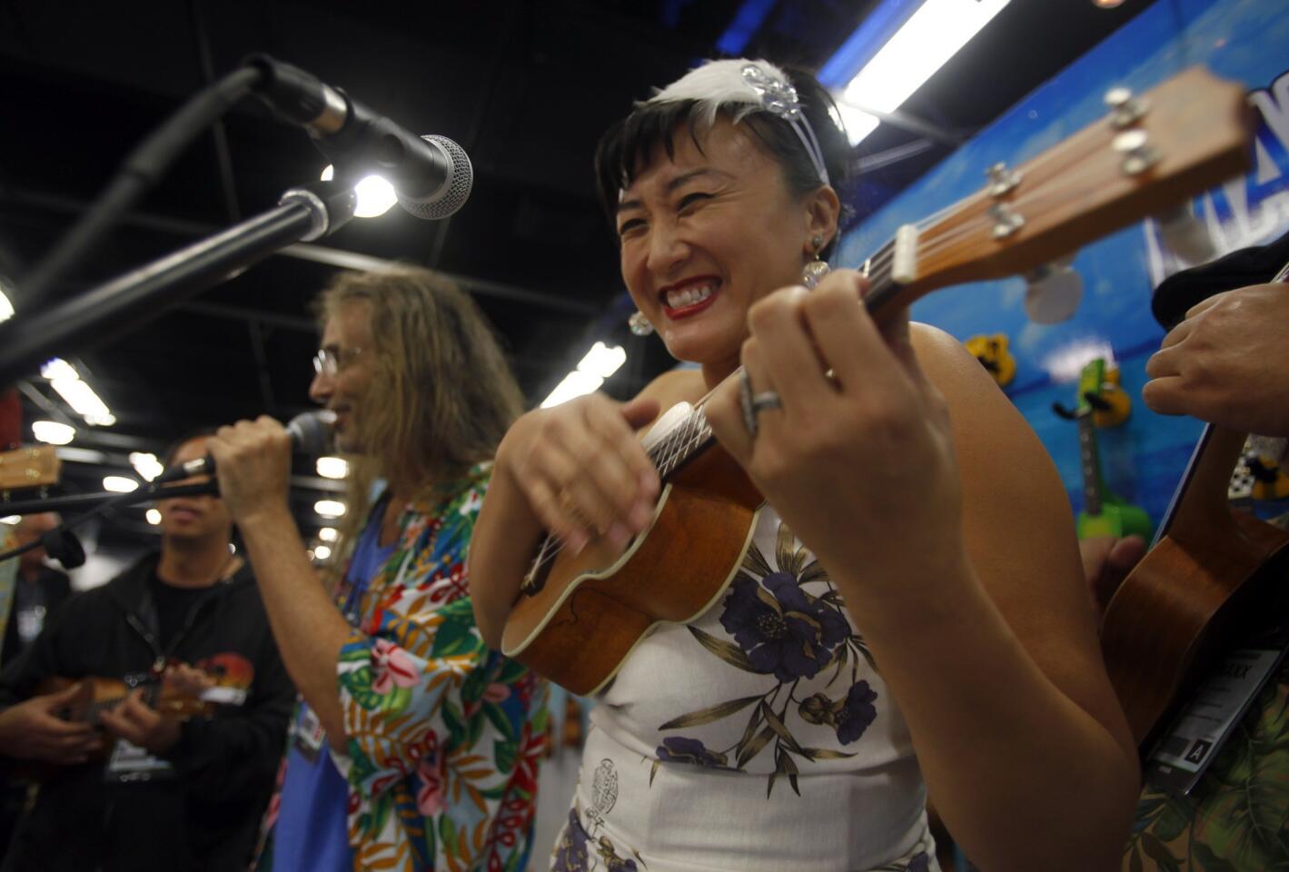 Claudia Choi plays a few licks at the Mahalo Ukulele booth at the NAMM Show in Anaheim.
