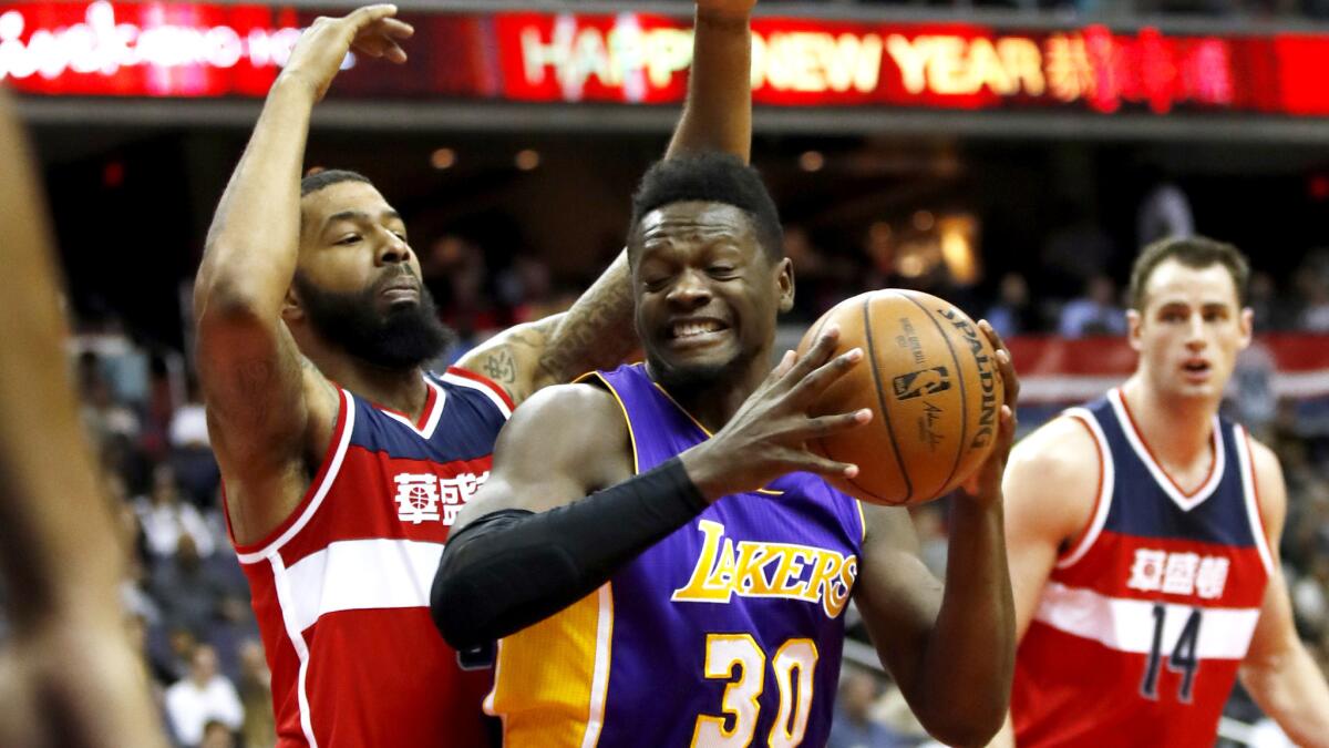 Lakers forward Julius Randle (30) tries to maneuver around Wizards forward Markieff Morris during the first half Thursday.