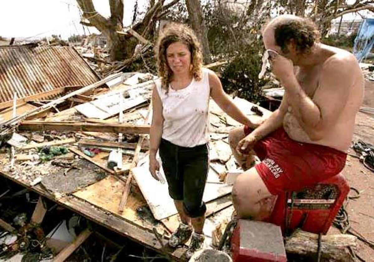 Sarah Fairchild and Bobby Chancey of Biloxi hung onto trees to survive. Their family has lost everything it owned.