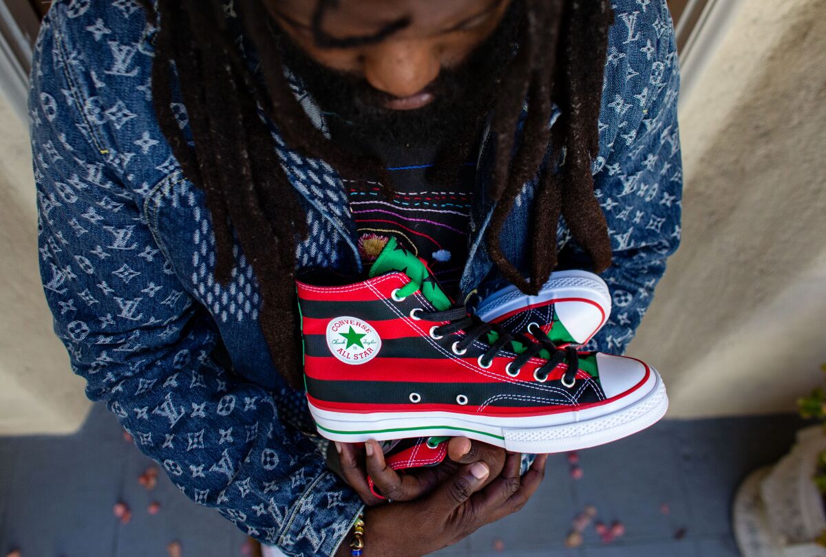 Tremaine Emory with the sneakers he designed inspired by the Pan-African flag