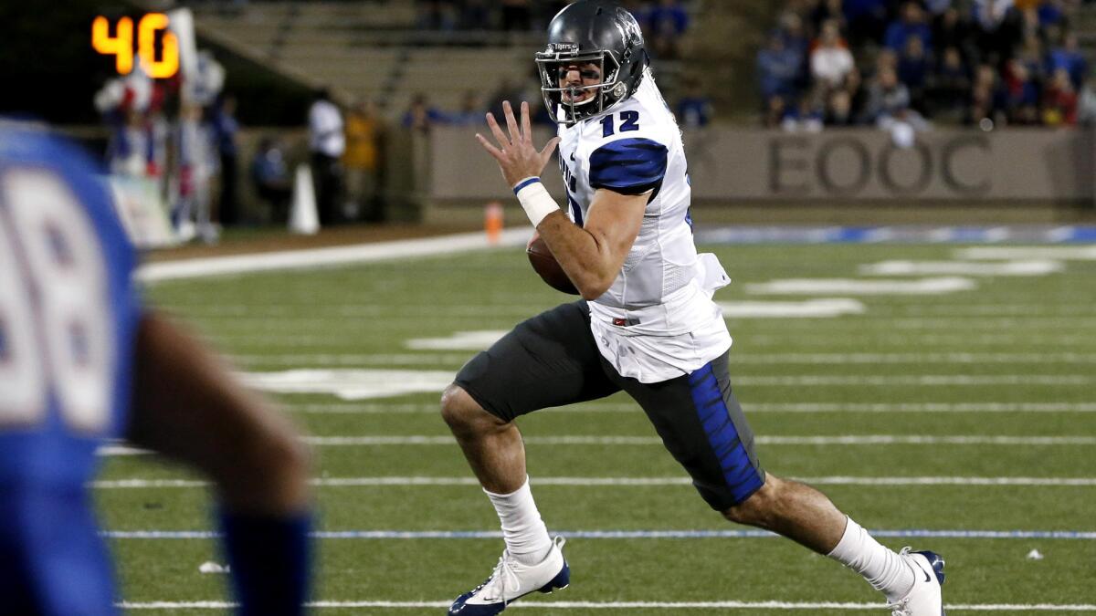 Memphis quarterback Paxton Lynch, who passed for a career-high 447 yards, runs for a touchdown in the third quarter against Tulsa on Friday night.