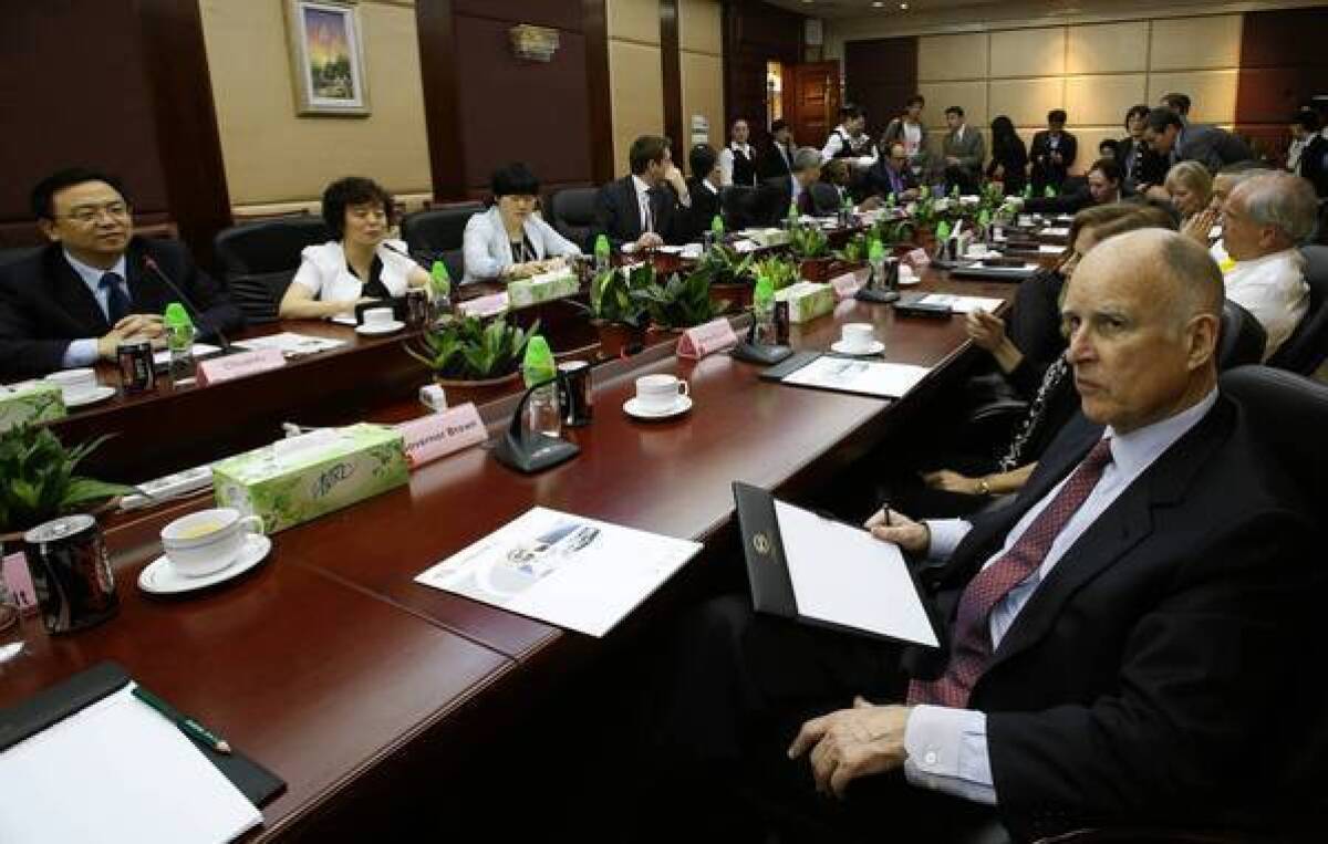 California Gov. Jerry Brown, right, meets with representatives of Chinese auto manufacturer BYD in Shenzhen, China, on Tuesday. During his trip to China, Brown repeatedly contrasted the speediness with which public works projects are completed in China with the obstacles, including environmental lawsuits, that such projects face in California.