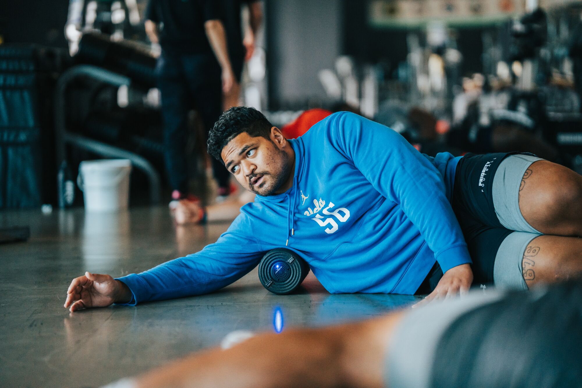 Former UCLA lineman Atonio Mafi stretches during a workout in Pensacola Beach, Fla.