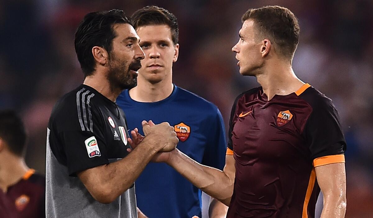 Roma's forward Edin Dzeko, right, shakes hands with Juventus' goalkeeper Gianluigi Buffon at the end of the Italian Serie A soccer match on Aug. 30.