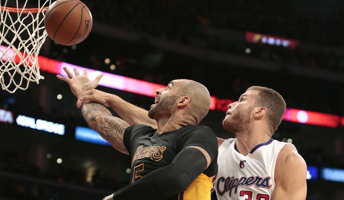 Lakers power forward Carlos Boozer is fouled by Clippers power forward Blake Griffin while attempting a layup in the during their game on Oct. 31.