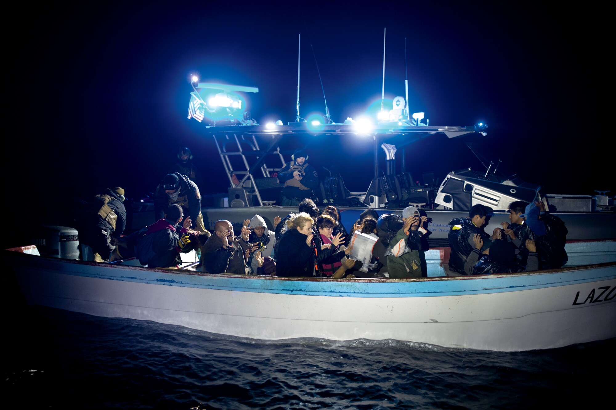 C.B.P. agents transfer migrants to the enforcement vessel