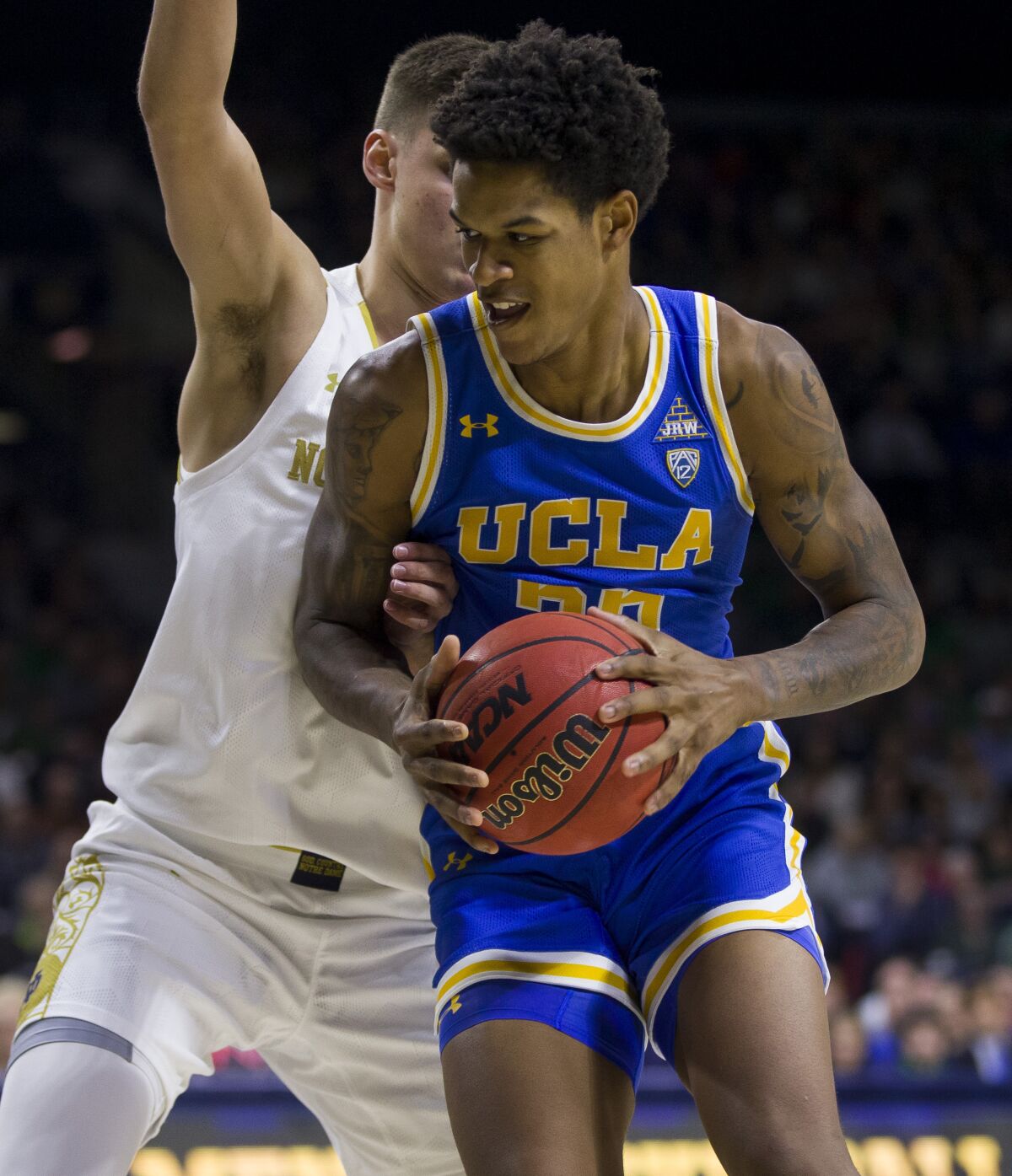 UCLA's Shareef O'Neal is pressured by Notre Dame's Nate Laszewski during a game Dec. 14.