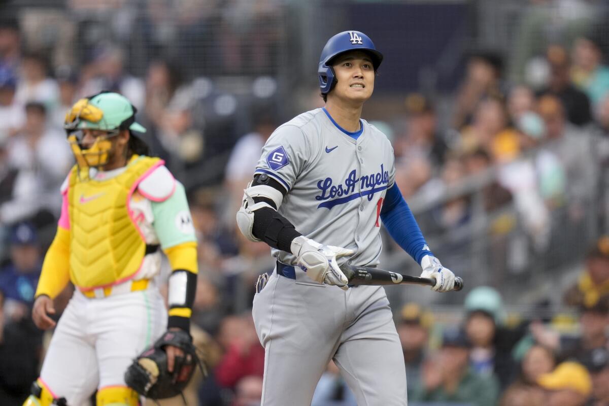 Dodgers star Shohei Ohtani reacts after striking out during the first inning Friday.