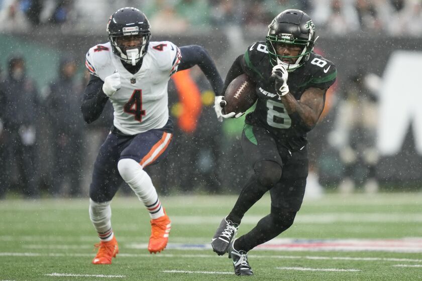 New York Jets wide receiver Elijah Moore (8) runs the ball against Chicago Bears safety Eddie Jackson (4) during the second quarter of an NFL football game, Sunday, Nov. 27, 2022, in East Rutherford, N.J. (AP Photo/John Minchillo)