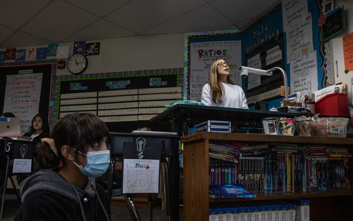 Allison Villa, 11, listens as Carolina Abrego teaches math to sixth graders at Rohr Elementary School.