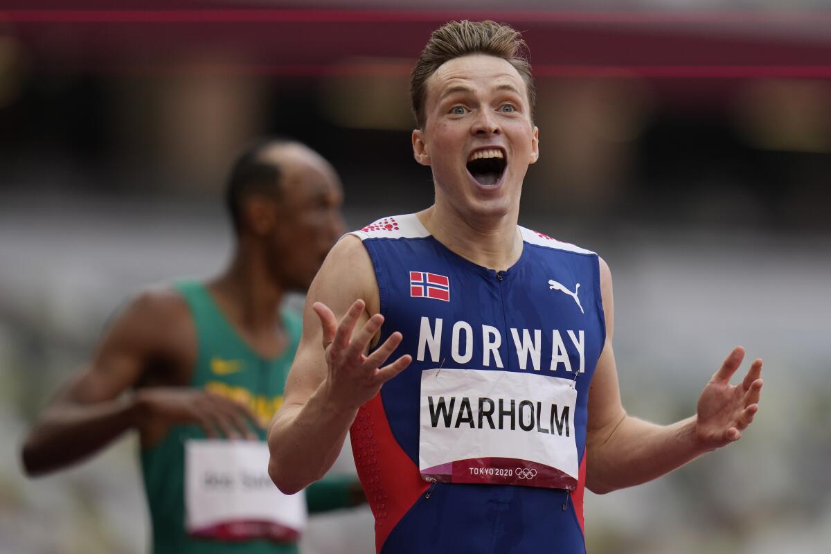 Karsten Warholm of Norway reacts after winning the men's 400-meter hurdles in world-record time at the Tokyo Olympics.