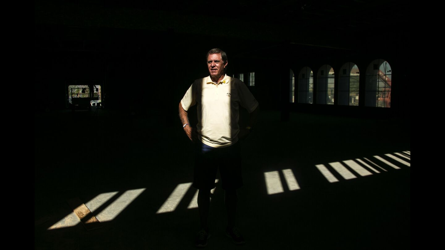 Tony Renaud, president of the Thermal Club, stands inside a race car storage facility under construction at the club.
