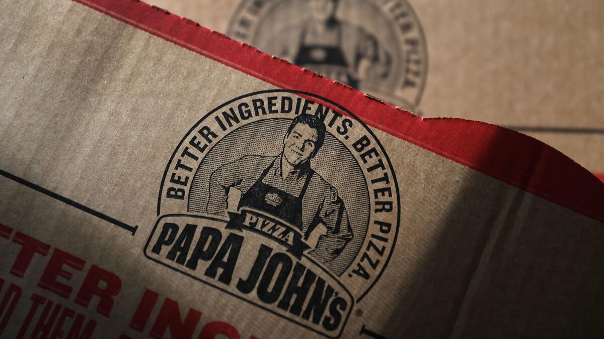 A Papa John's pizza box features an image of founder John Schnatter. The company is trying to distance itself from its former chief executive.