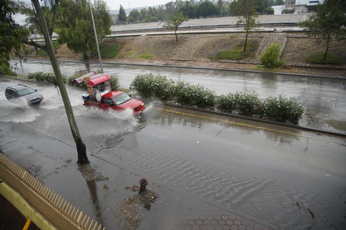 Traffic in Zona Rio sloshes through flooded streets on Sunday in Tijuana.