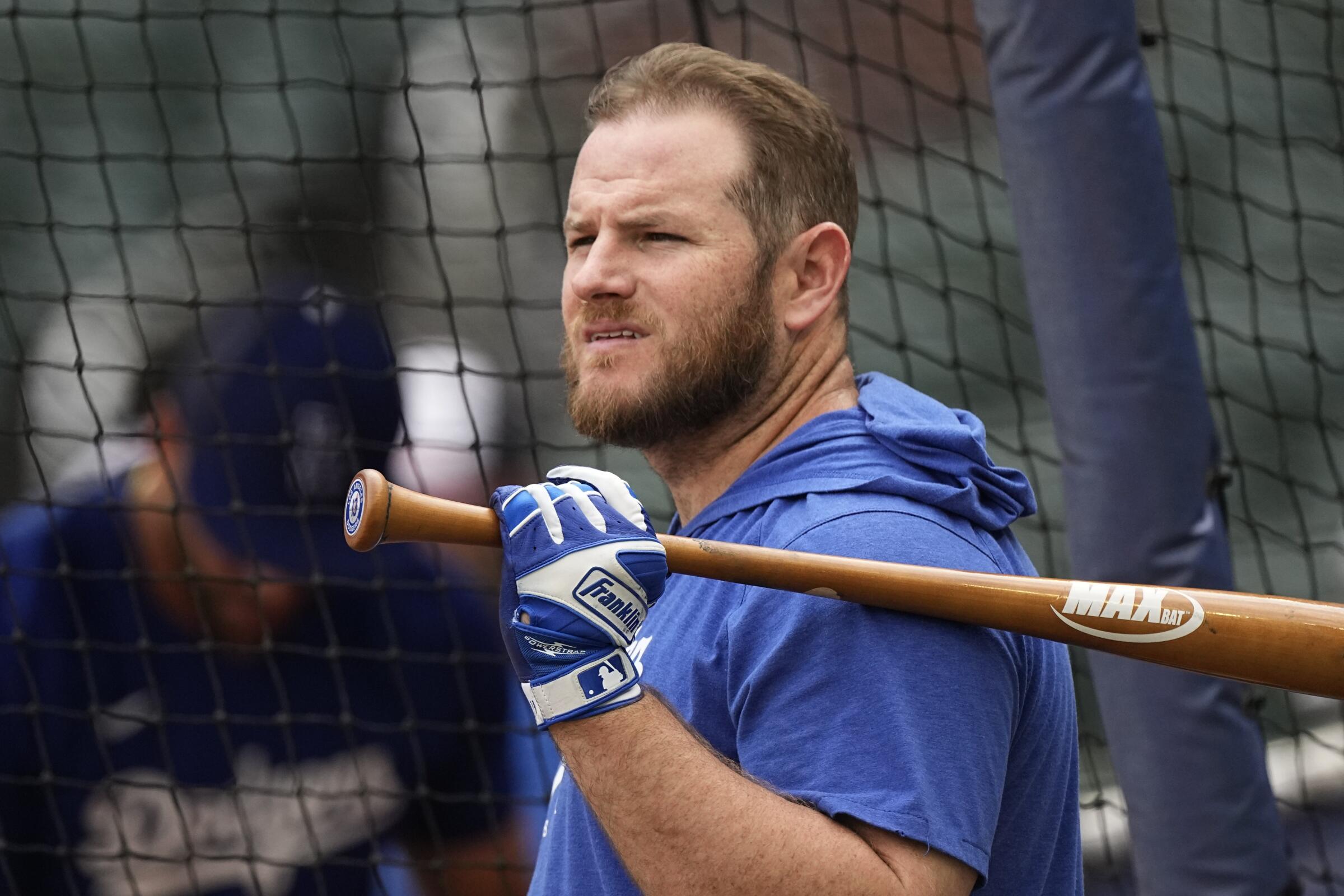 Max Muncy of the Dodgers holds a bat over his shoulder while waiting for batting practice at Truist Park in Atlanta.