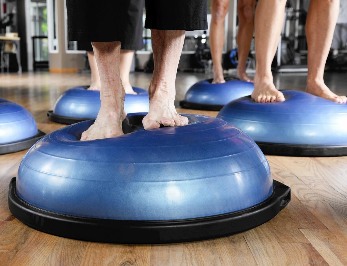 A Pilates class uses BOSU balls for balance exercises, which become even more important as we get older.