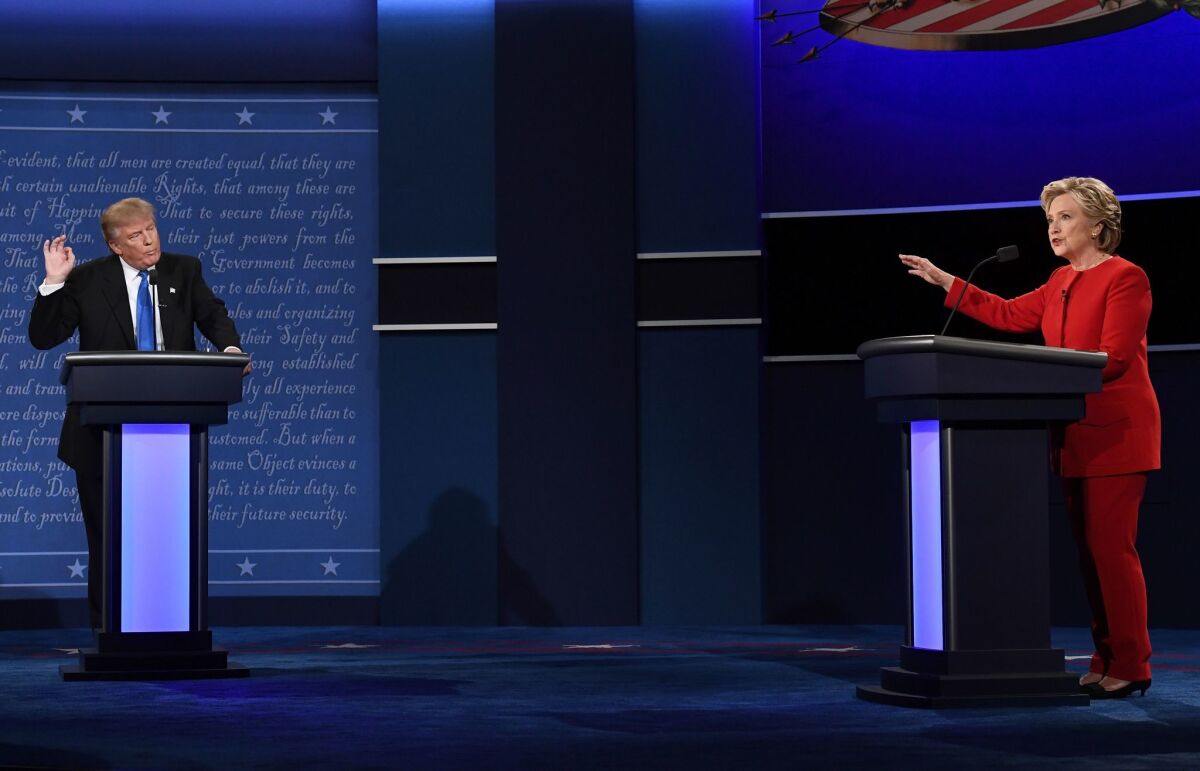 Republican nominee Donald Trump and nominee Hillary Clinton speak during the first presidential debate at Hofstra University in Hempstead, New York on September 26, 2016.
