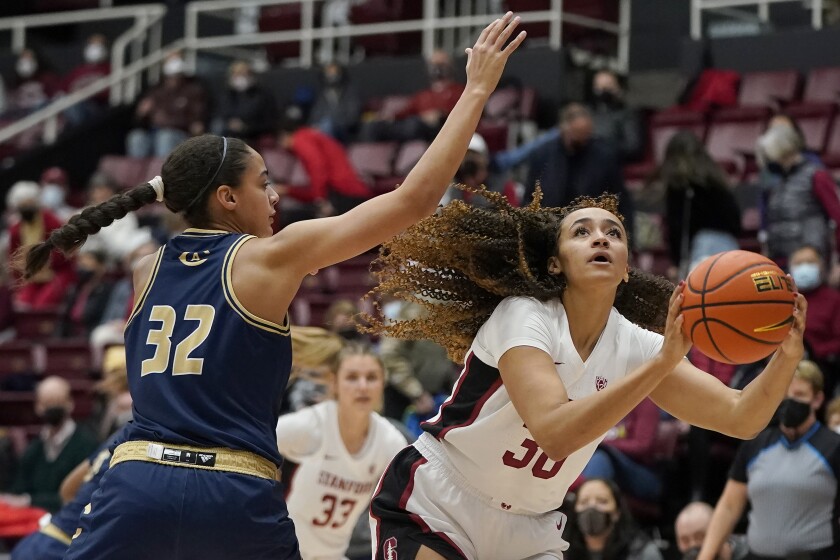 Stanford guard Haley Jones, right, shoots against UC Davis forward Cierra Hall (32) during the first half of an NCAA college basketball game in Stanford, Calif., Wednesday, Dec. 15, 2021. (AP Photo/Jeff Chiu)