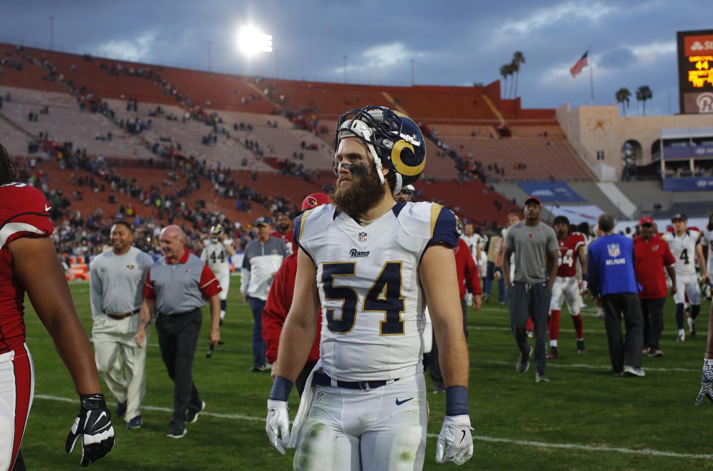 Rams linebacker Bryce Hager (54) leaves the Coliseum field after the last game of the season, a 44-6 loss to the Cardinals.