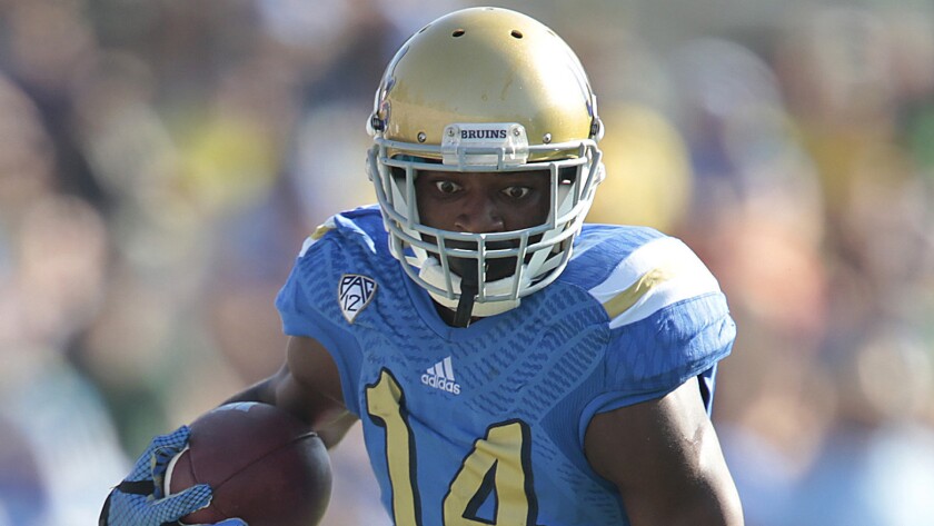 UCLA wide receiver Mossi Johnson runs after making a catch during the Bruins' loss to Oregon on Oct. 11.