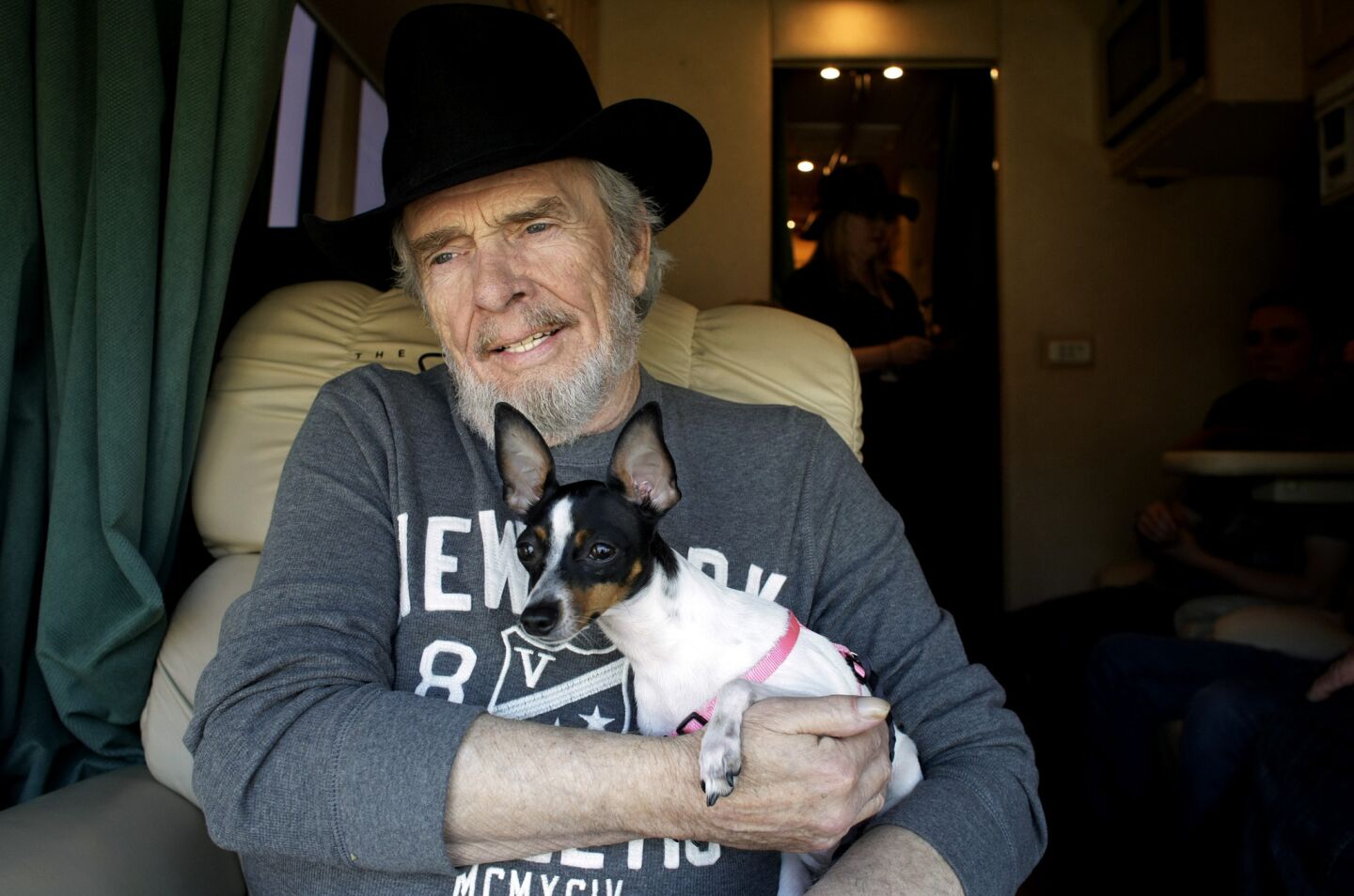 Merle Haggard sits on his bus with Fanny Mae before performing at the Stagecoach Music Festival in 2010.
