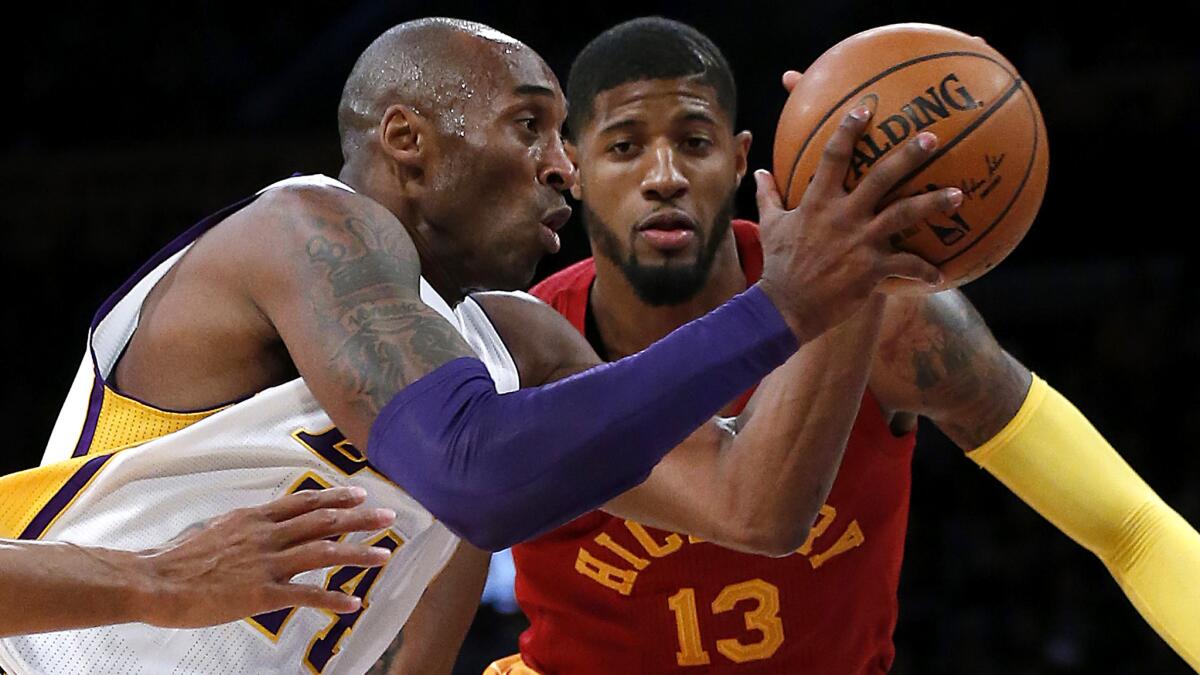 Lakers guard Kobe Bryant drives past Pacers forward Paul George during a game on Nov. 29.