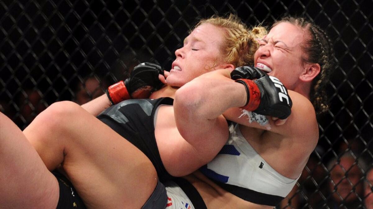 Miesha Tate, right, battles Holly Holm during a women's bantamweight title fight at UFC 196 in Las Vegas on March 5.