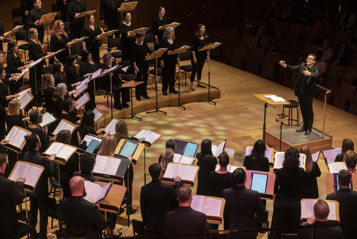 A man conducts singers.