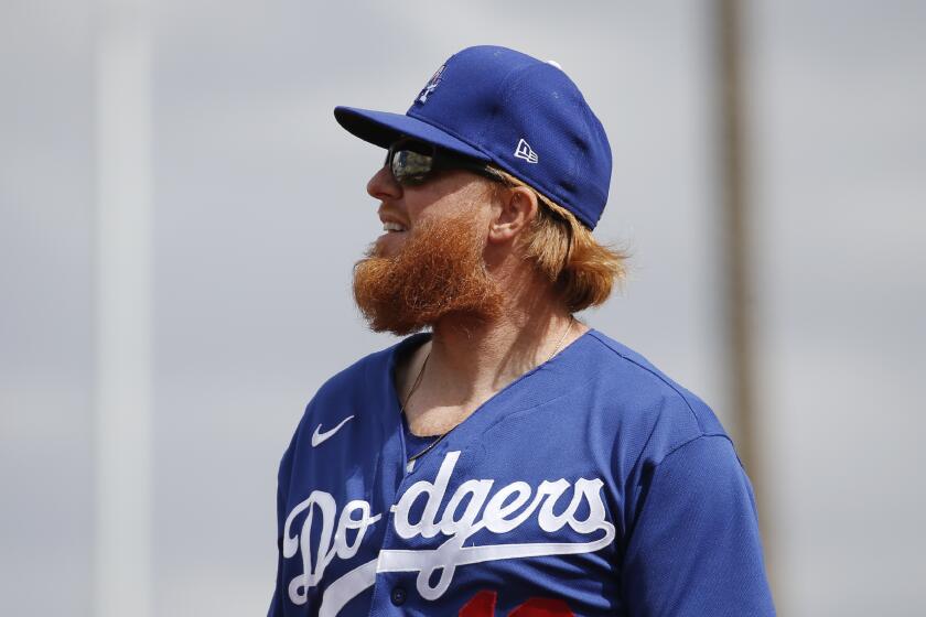 Los Angeles Dodgers third baseman Justin Turner watches the flight of a foul ball during the first inning of a spring training baseball game against the Cincinnati Reds Monday, March 2, 2020, in Goodyear, Ariz. (AP Photo/Ross D. Franklin)