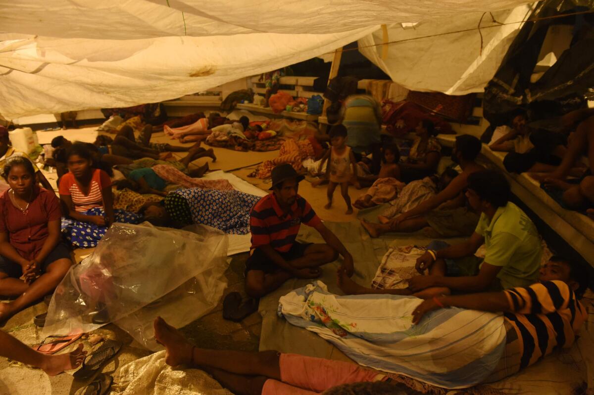 Sri Lankan flood victims rest by a road camp in the Kelaniya suburb of the capital, Colombo.