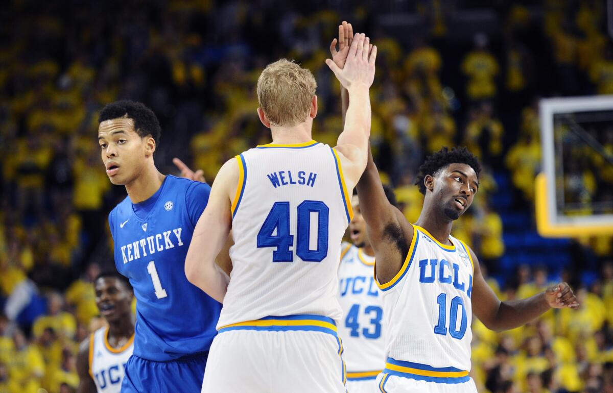 UCLA's Thomas Welsh and Isaac Hamilton celebrate next to Kentucky's Skal Labissiere in December.