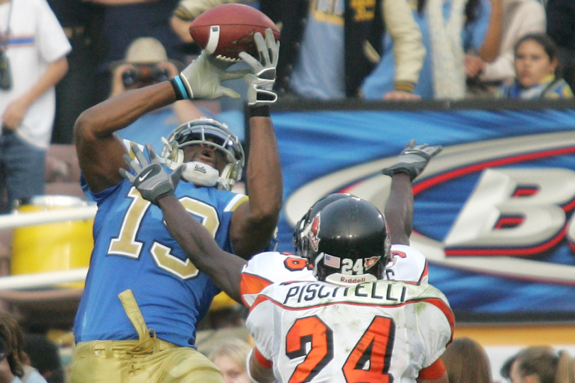 UCLA wide receiver Mercedes Lewis, left, catches a touchdown pass from Drew Olson.