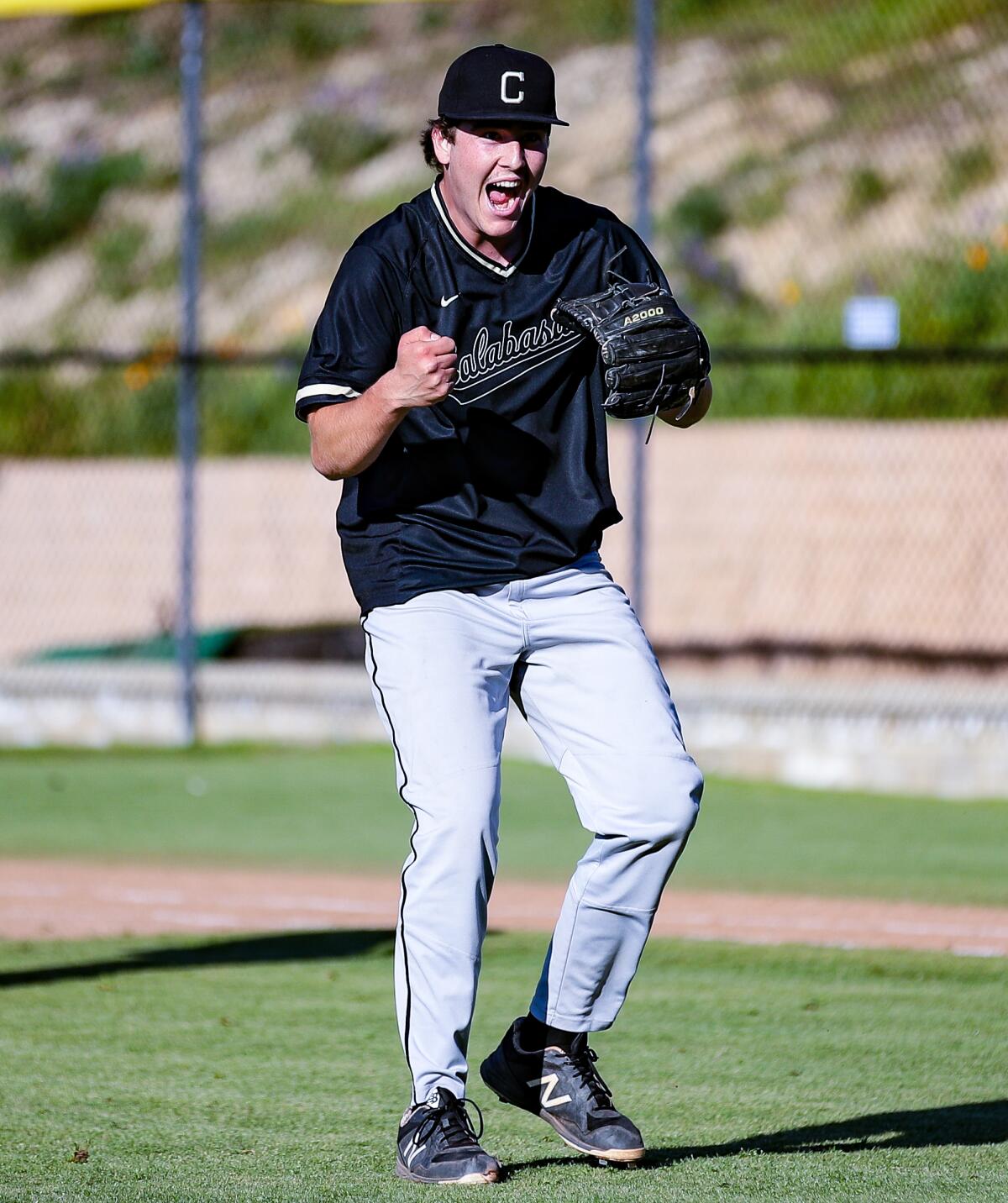 Jordan Kingston of Calabasas celebrates after throwing a complete game to hand Westlake its first defeat 3-2.