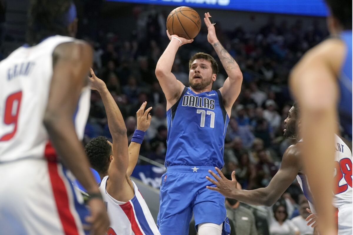 Dallas Mavericks guard Luka Doncic (77) shoots against the Detroit Pistons during the first quarter of an NBA basketball game in Dallas, Tuesday, Feb. 8, 2022. (AP Photo/LM Otero)