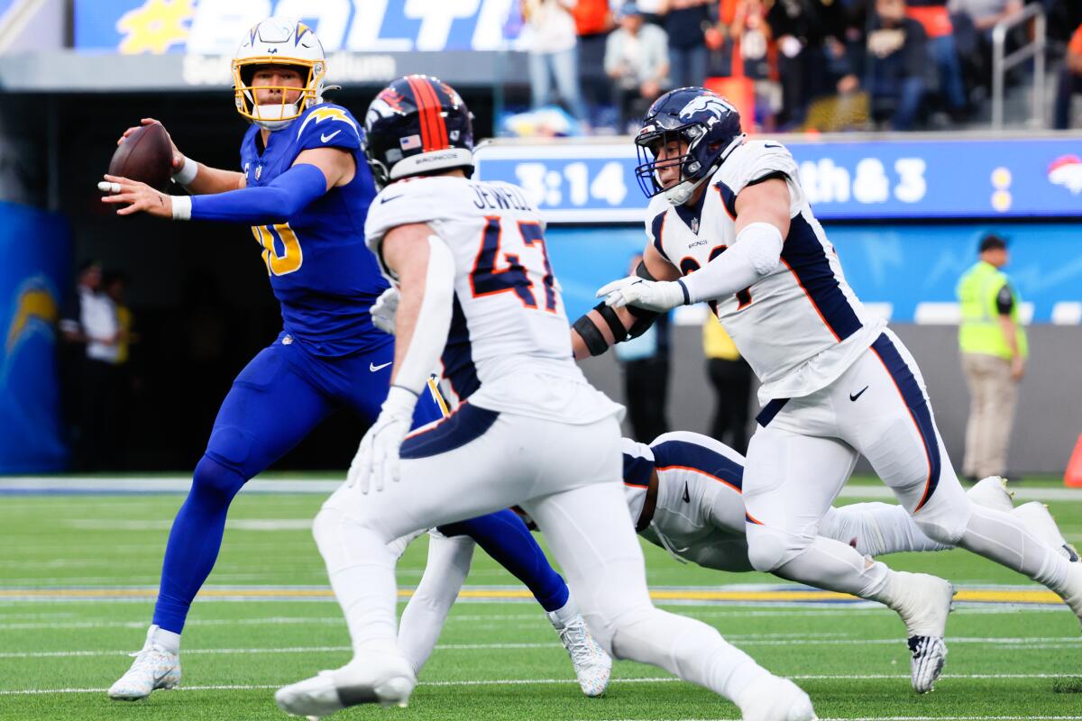 Chargers quarterback Justin Herbert looks to pass against the Denver Broncos in the first half Sunday.