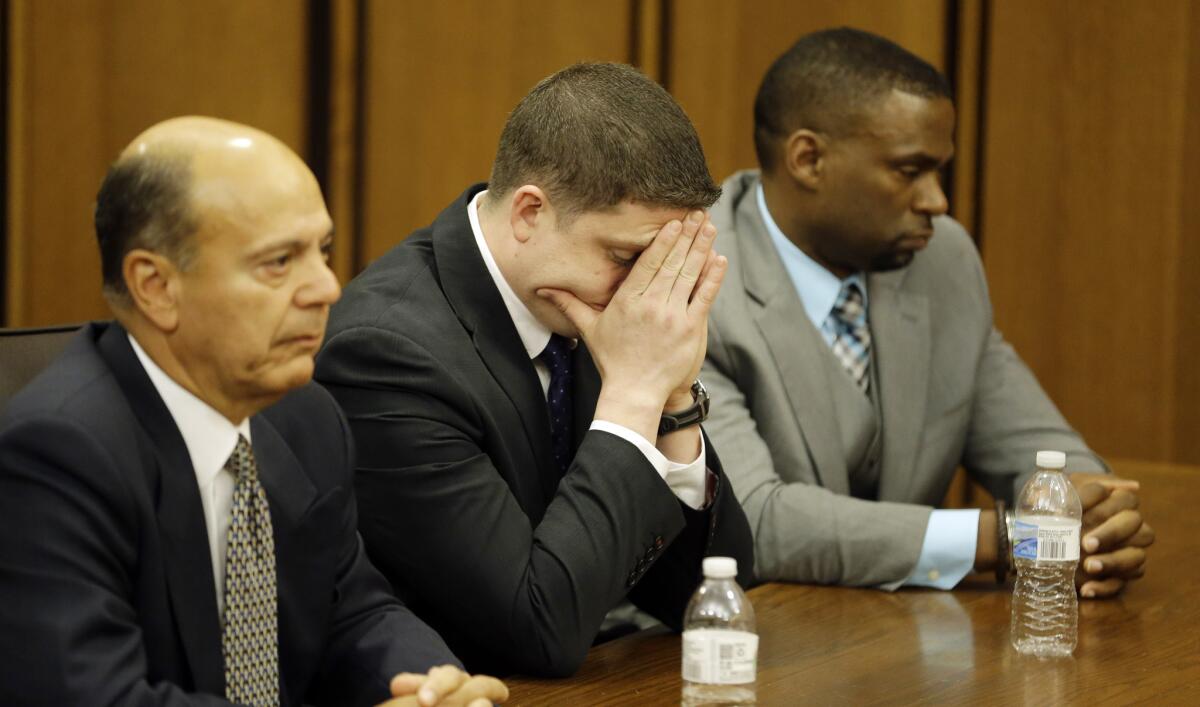 Cleveland police Officer Michael Brelo, center, reacts as the verdict is read at his trial. A judge who acquitted him Saturday said he would "not sacrifice" Brelo "to a public frustrated by historical mistreatment at the hands of other officers."