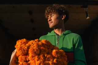 Young flower market worker, Angel Soteloa, unloading a fresh cempasuchil truckload.