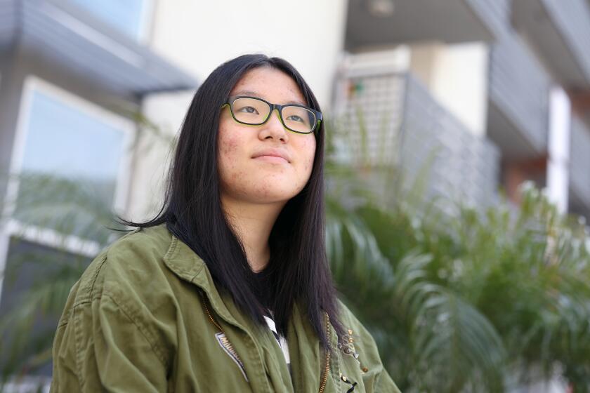LOS ANGELES, CA - MARCH 30: Mina Lee, a junior at John Marshall High school who has decided to finish the school year remotely, stands for a portrait outside her home in Koreatown on Tuesday, March 30, 2021 in Los Angeles, CA. She is not a fan of the Zoom-in-school hybrid set-up. (Dania Maxwell / Los Angeles Times)