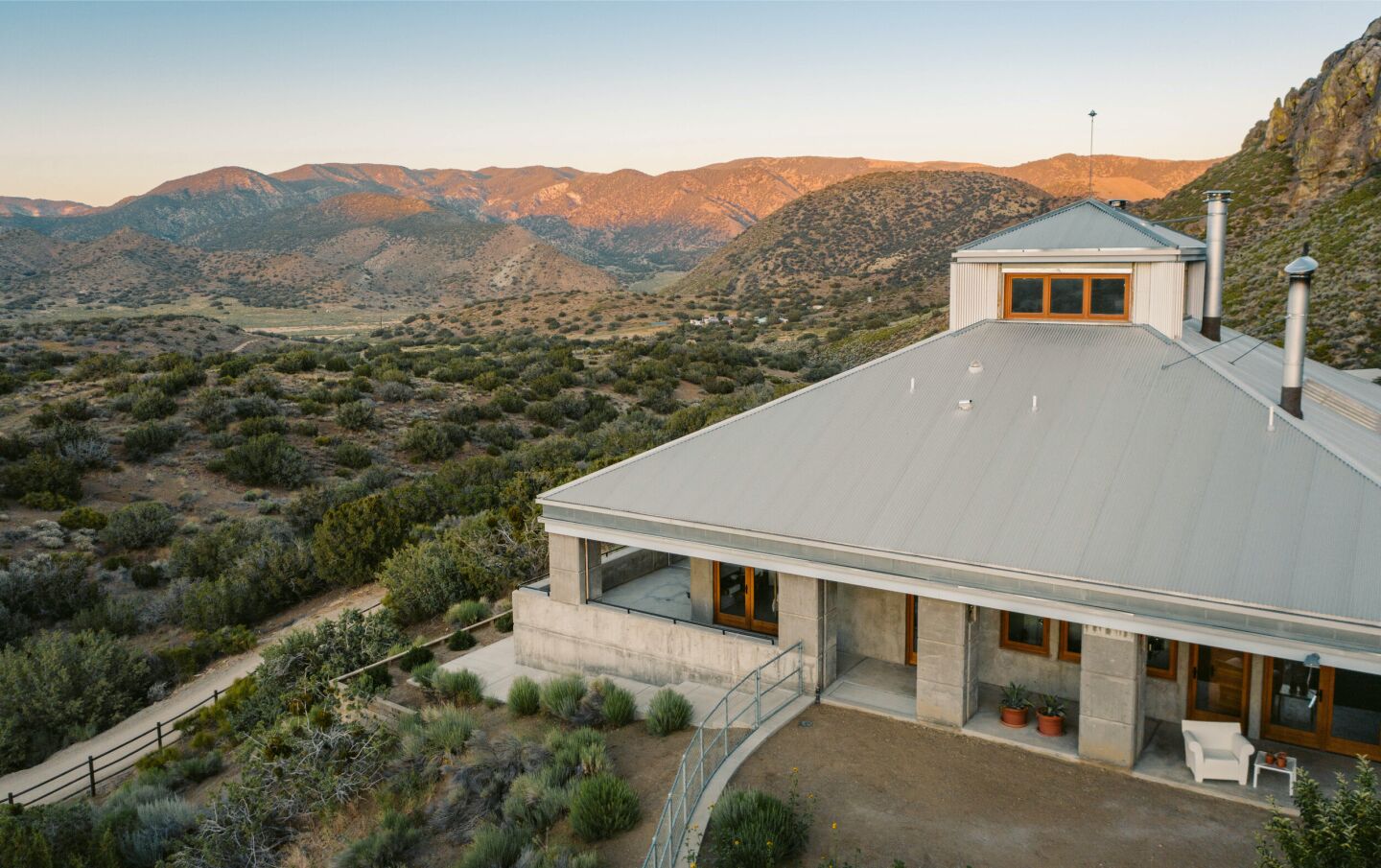 An aerial view shows the steel roof and concrete pillars of the home.