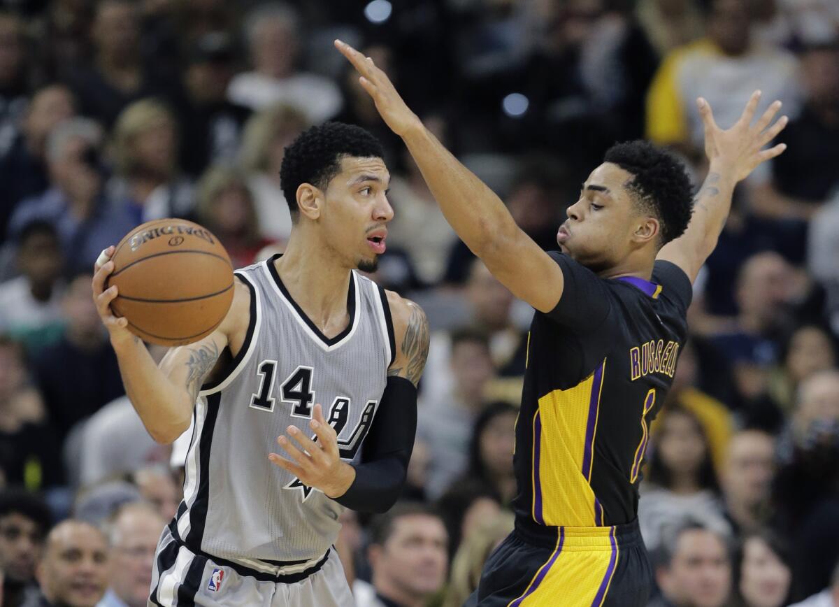 San Antonio Spurs guard Danny Green (14) is defended by Los Angeles Lakers guard D'Angelo Russell (1) during the first half on Friday.