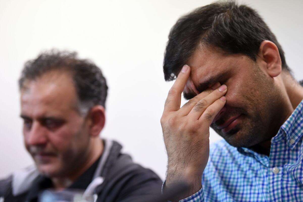 Akhtar Iqbal, left, husband of Sugra Dawood, and Mohammed Shoaib, husband of Khadija Dawood, react during a news conference Tuesday in Bradford, northern England. The men fear their wives took their children and fled to become part of the Islamic State.
