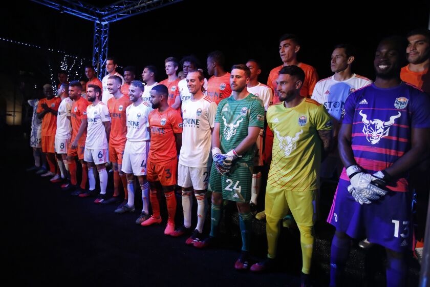 The San Diego Loyal soccer team unveiled their orange and white with green trim uniforms in Liberty Station on Feb. 13, 2020. The goalies are at right.