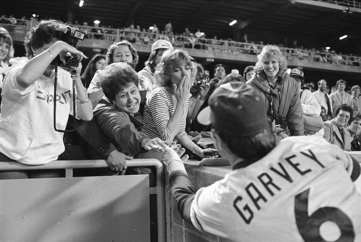 Padres player Steve Garvey greets some of his loyal fans at Dodger Stadium in a black and white photo.