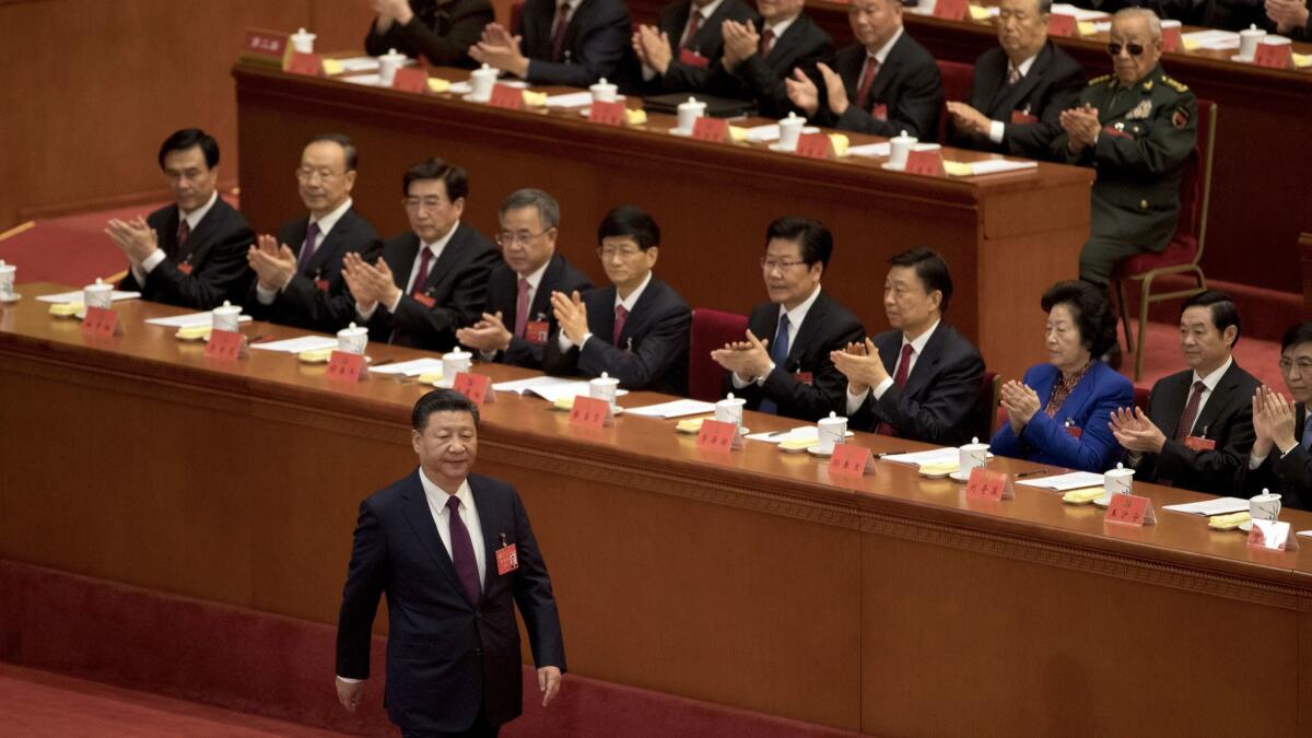 Chinese President Xi Jinping is applauded as he walks to the podium to deliver his speech at the opening ceremony of the 19th Party Congress held at the Great Hall of the People in Beijing.