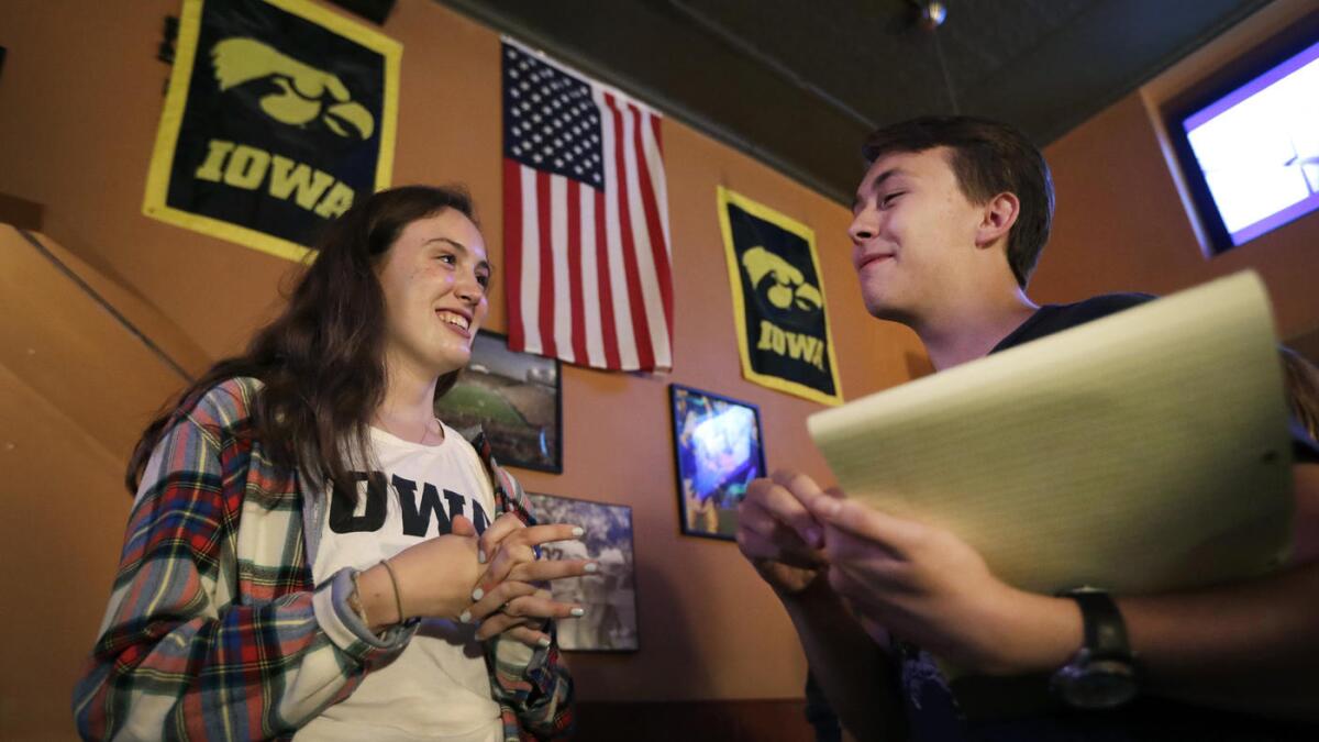 University of Iowa students Abigail Simon and Mitchell Dunn talk during a Hillary Clinton campaign organizing event in Iowa City.