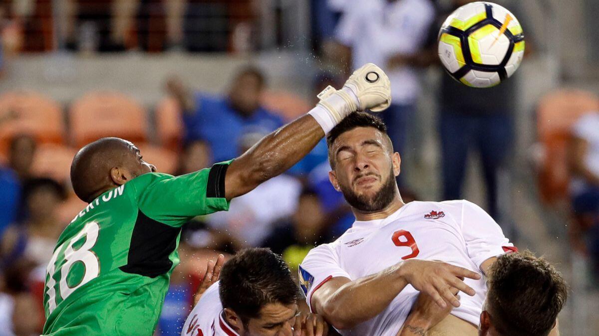 Costa Rica goalkeeper Patrick Pemberton (18) makes a save against Canada forward Lucas Cavallini (9) in the second half of a CONCACAF Gold Cup soccer match in Houston on Tuesday.